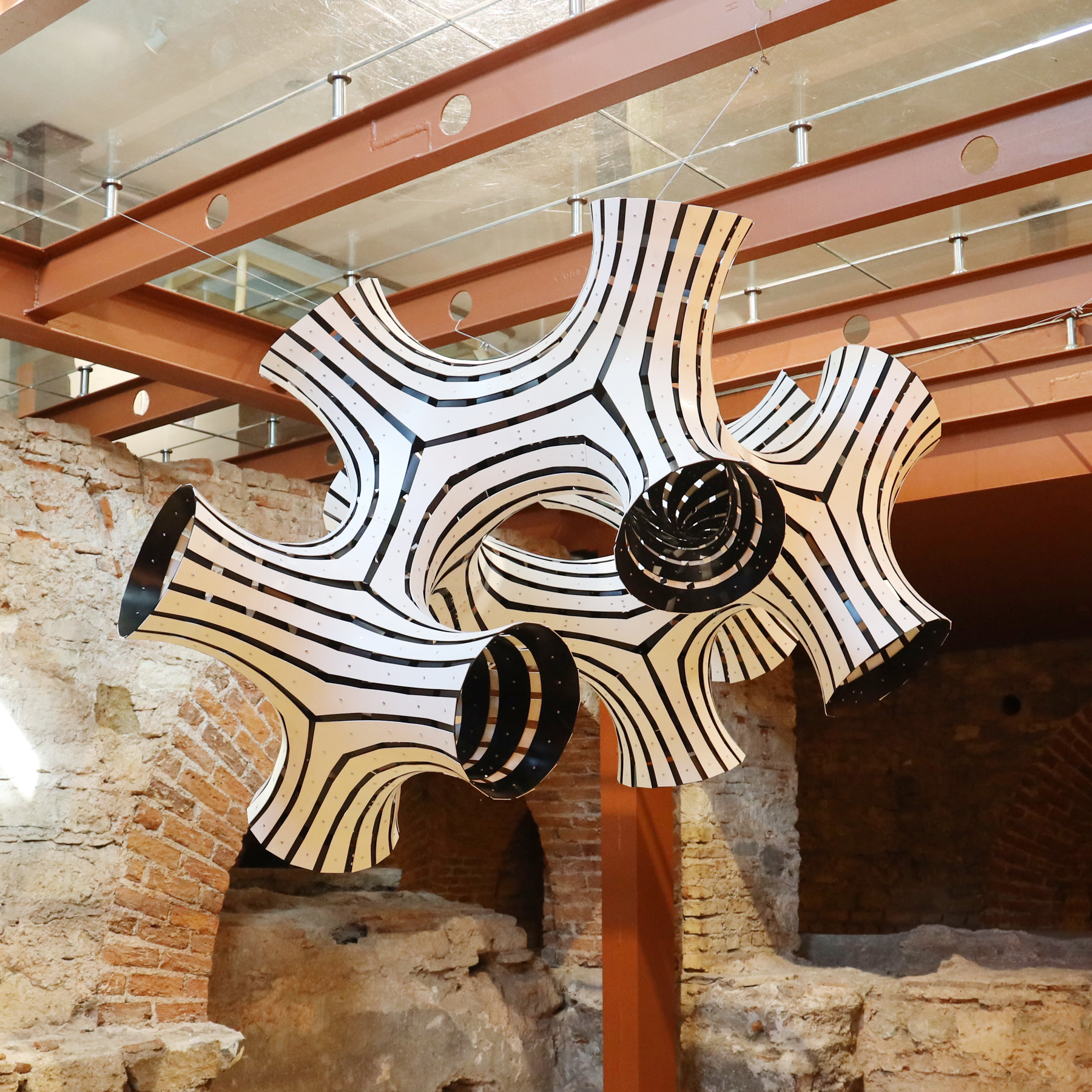 Occa suspended installation showing its striped branching surfaces